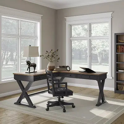 L-shaped black home office desk with wood-tone top, X-frame legs, and matching drawer storage, paired with a black upholstered office chair.